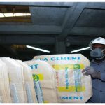 Factory worker with cement bags