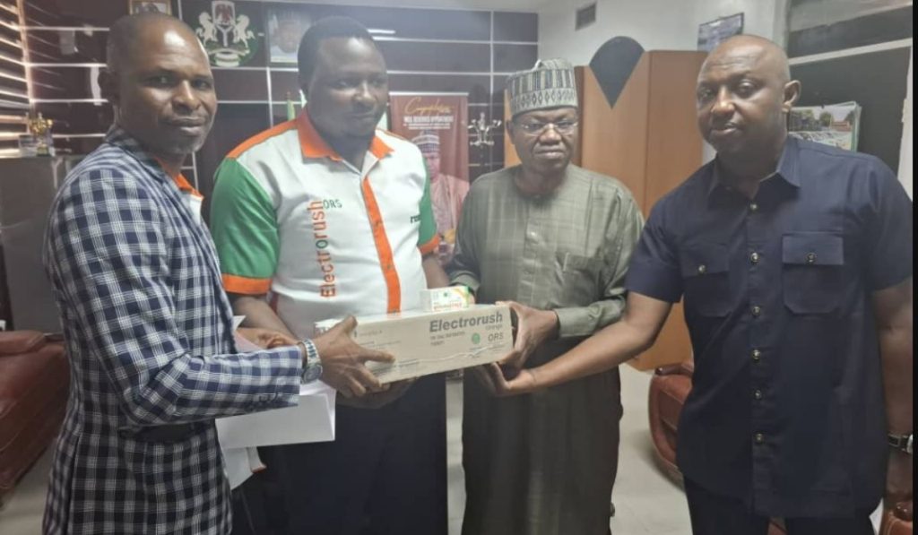 Group photo of four men holding a pack of Electrorush ORS drugs