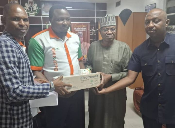 Group photo of four men holding a pack of Electrorush ORS drugs