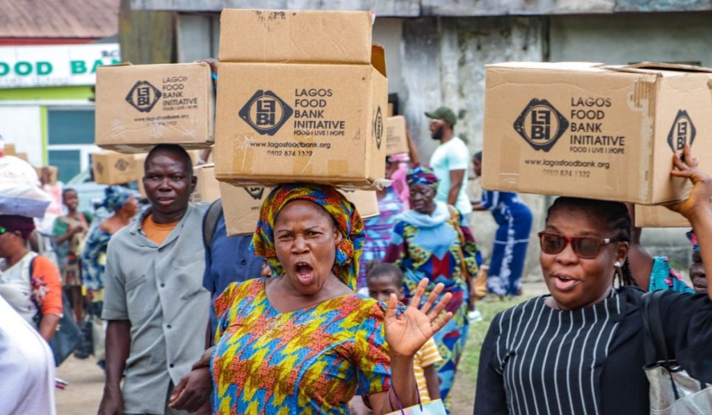 A crowd of women carrying box from Lagos Food Bank