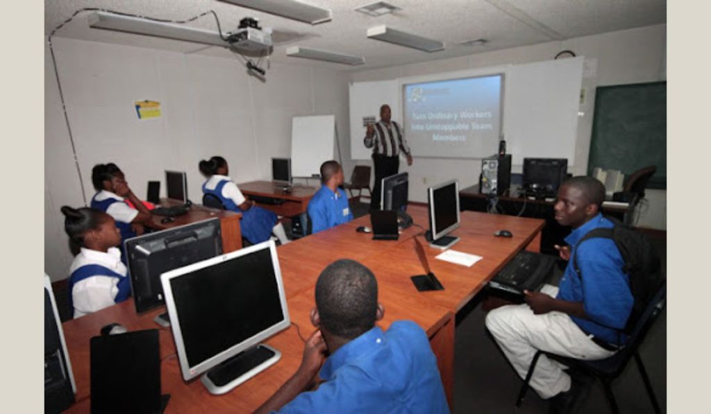 Students in a classroom and a teacher teaching