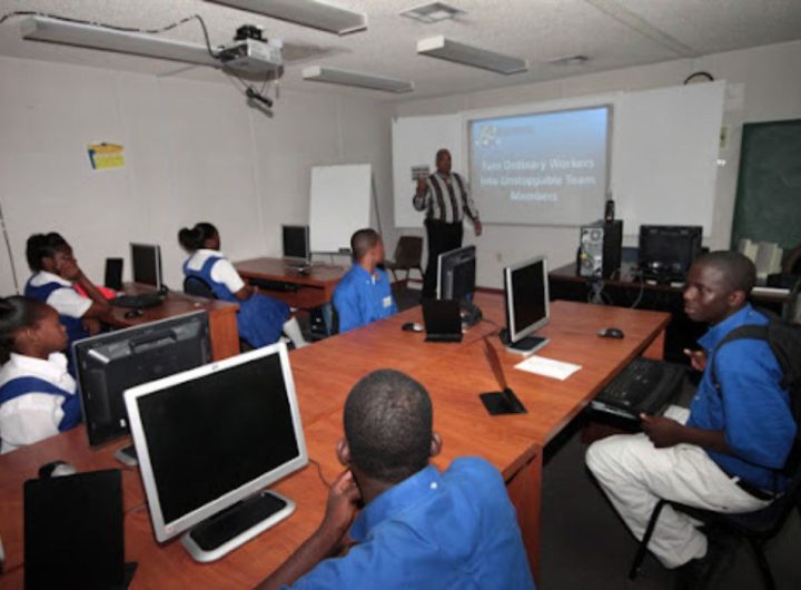 Students in a classroom and a teacher teaching