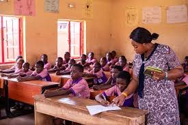 A female teacher and students in a classroom