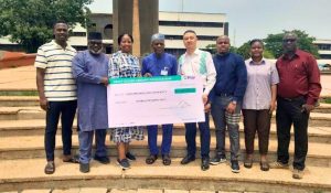 OPay scholarship group picture with a cheque board