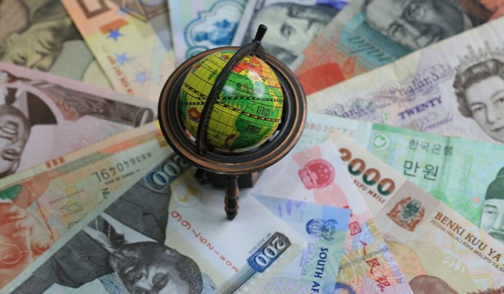 Image of a globe on different currencies, representing global economy