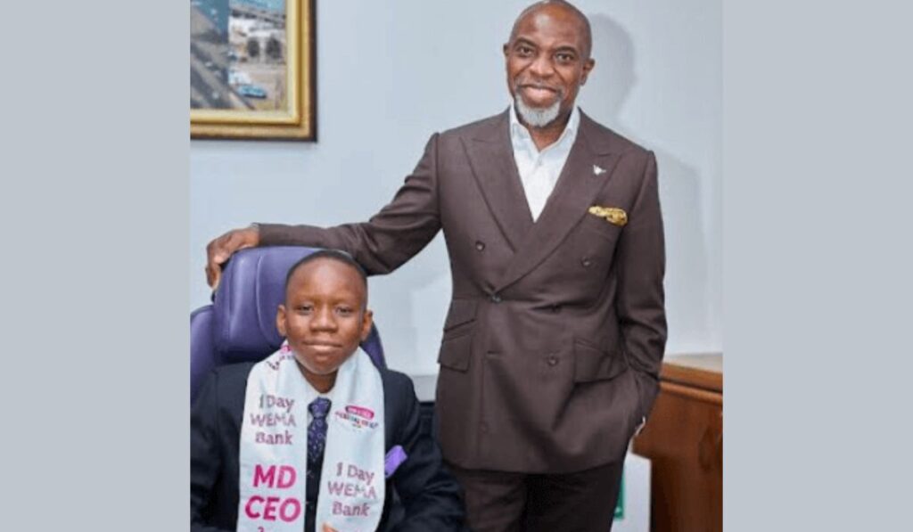 Moruf Oseni, Managing Director (MD) at Wema Bank posing with student he donated his one-day salary to for Children's Day Celebration