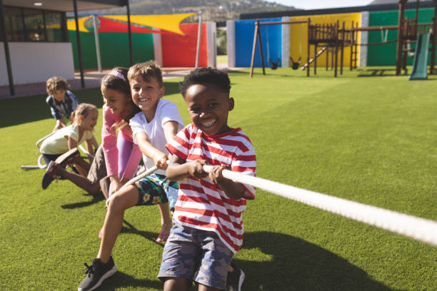 happy Children playing tug of war