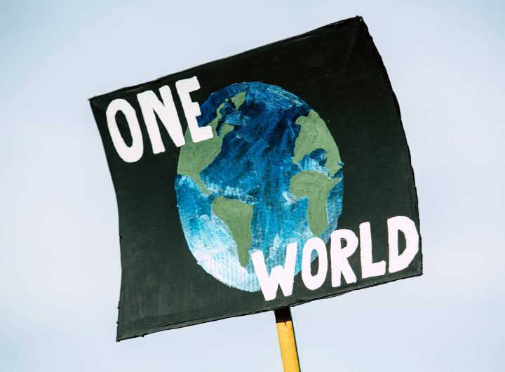 A poster showing one world with the globe of the earth as background