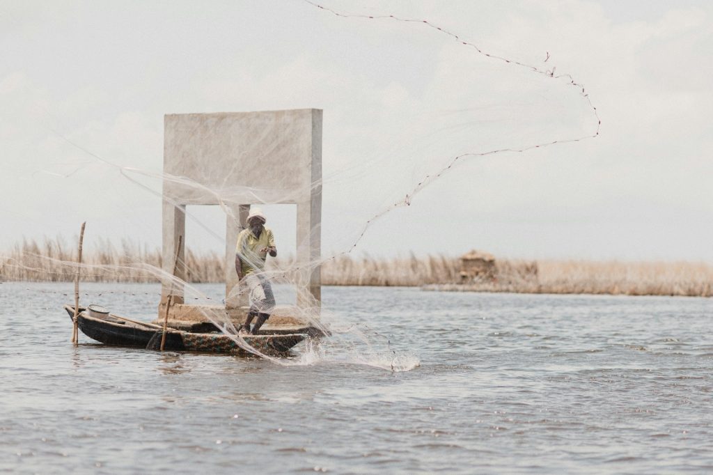 Lone african fisherman casting net