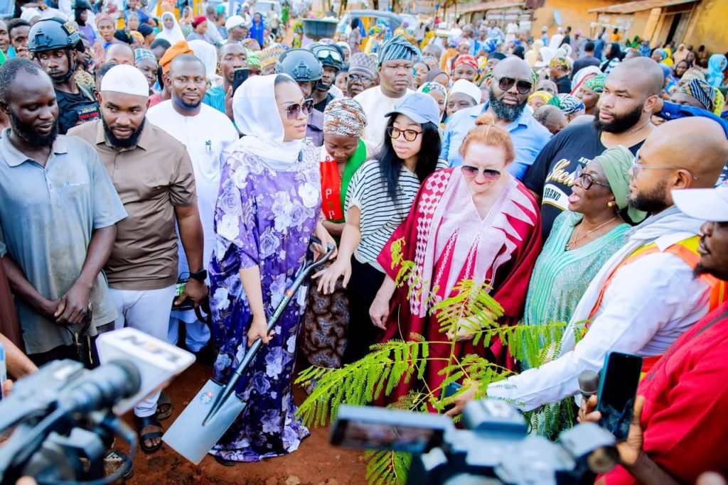 Senator holding shovel during tree planting