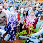Senator holding shovel during tree planting