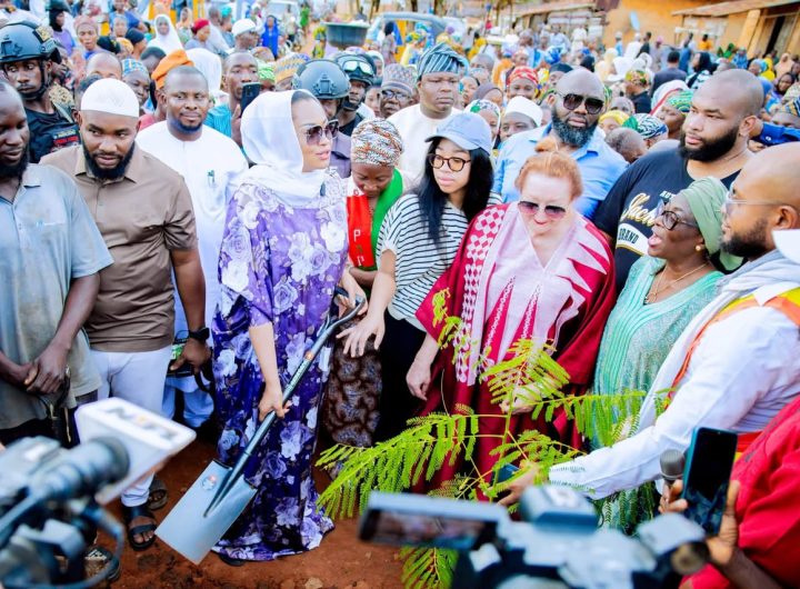 Senator holding shovel during tree planting