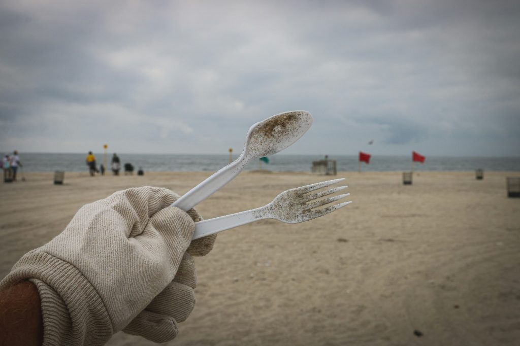 Volunteer holding up waste from beach
