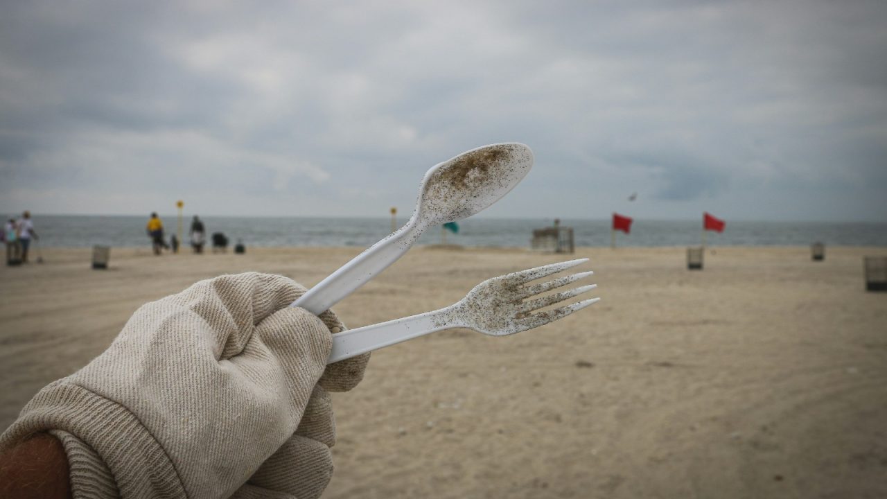 Volunteer holding up waste from beach