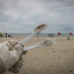 Volunteer holding up waste from beach