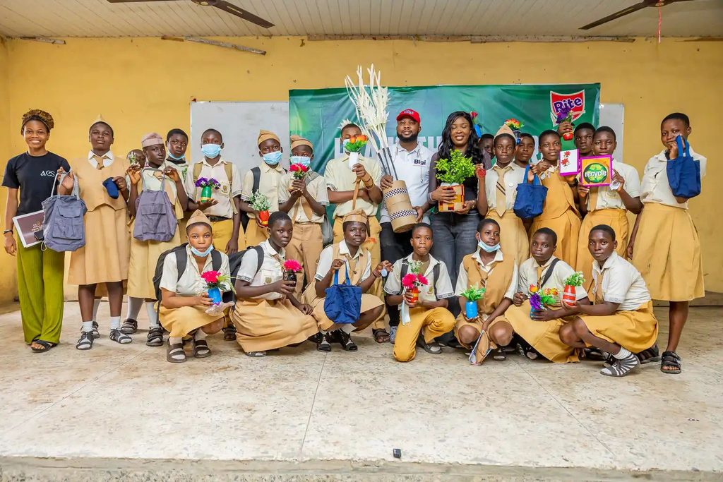 Dr Chinedu Azih and students showing off recycled products
