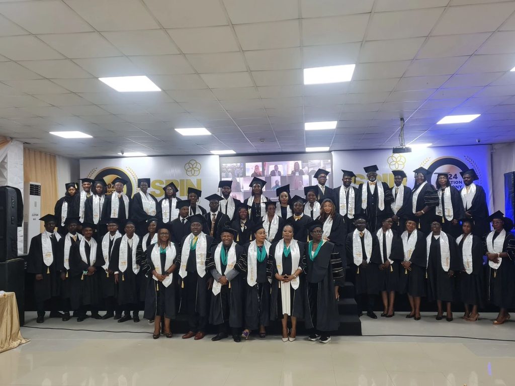 Dr Eustace Onuegbu with inductees at SPIN Induction
