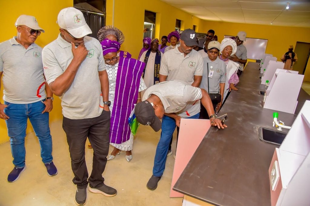 Nigeria customs official inspecting laboratories at Ife Girls High School